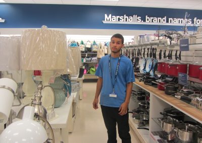 Photo of a young man standing inside a Marshalls store