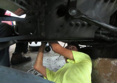 Photo of a young man working under a car