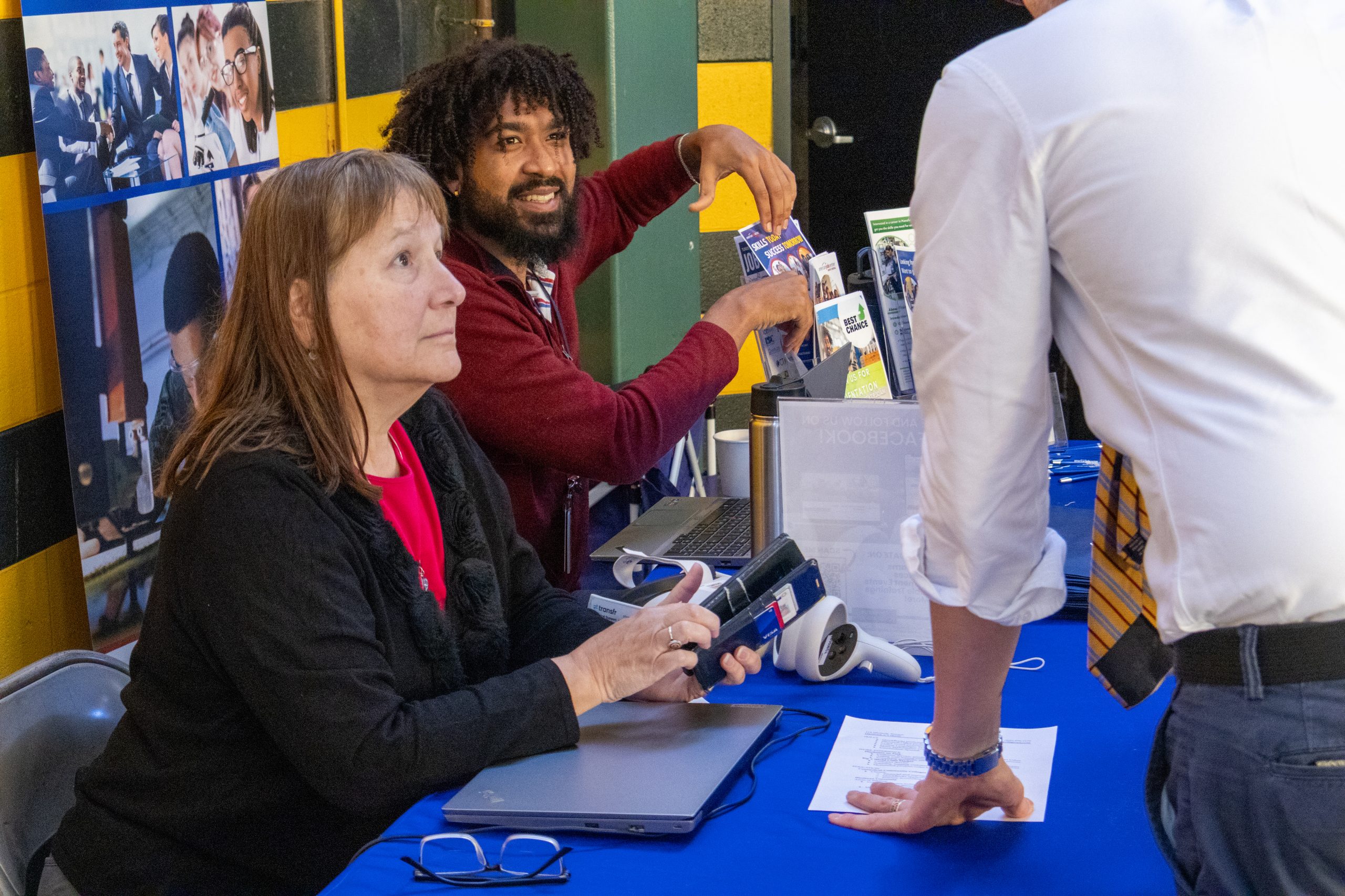 Career Advisors at a Job fair providing job training program information to a jobseeker