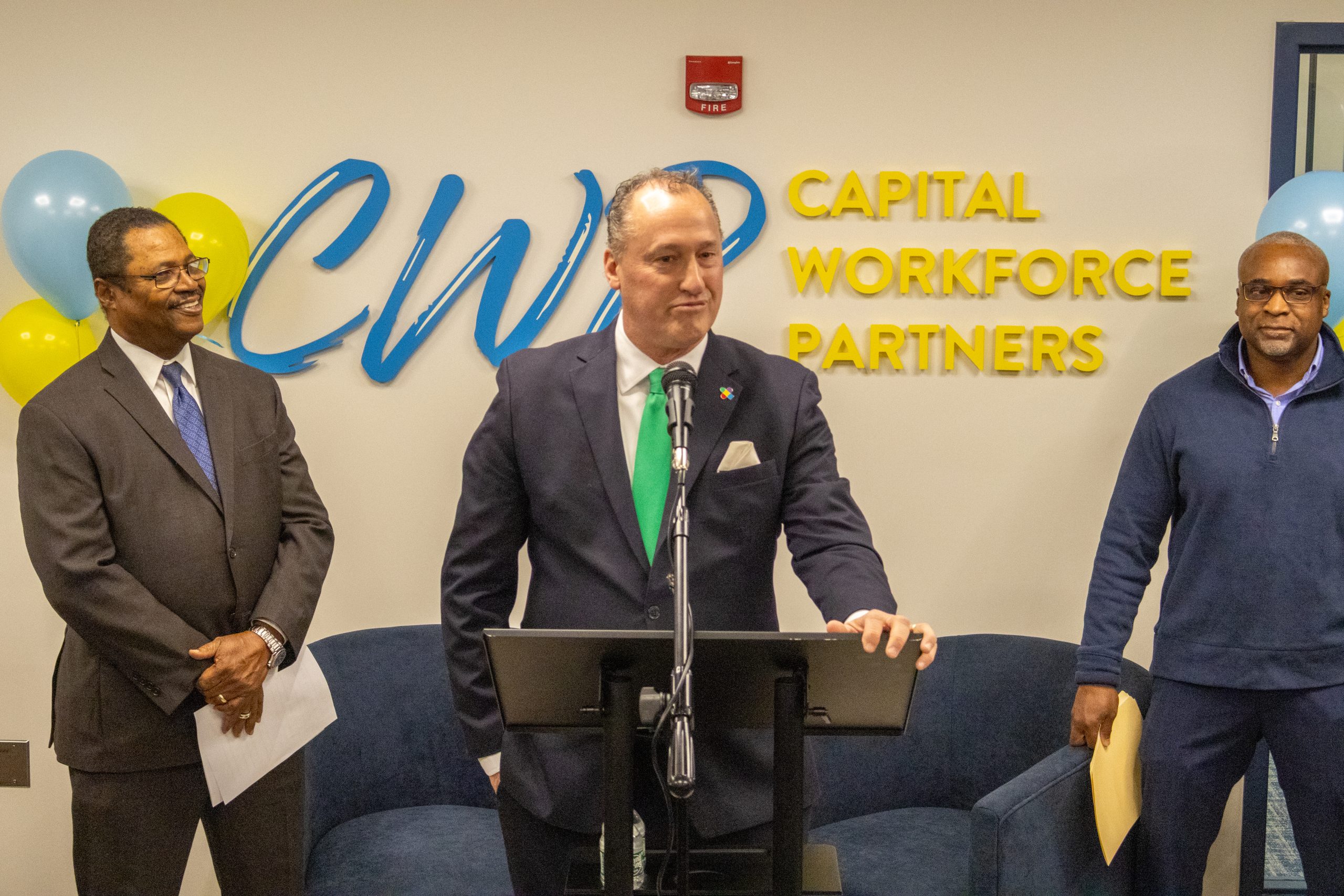 Manchester Mayor at a podium, speaking at the CWP Headquarters in Hartford