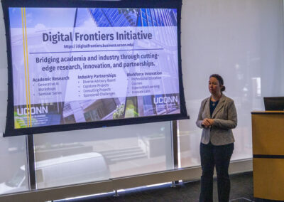 woman presenting in front of a projector screen