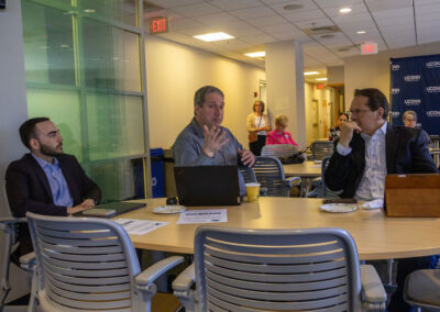 Group of people sitting at a meeting in a cafeteria