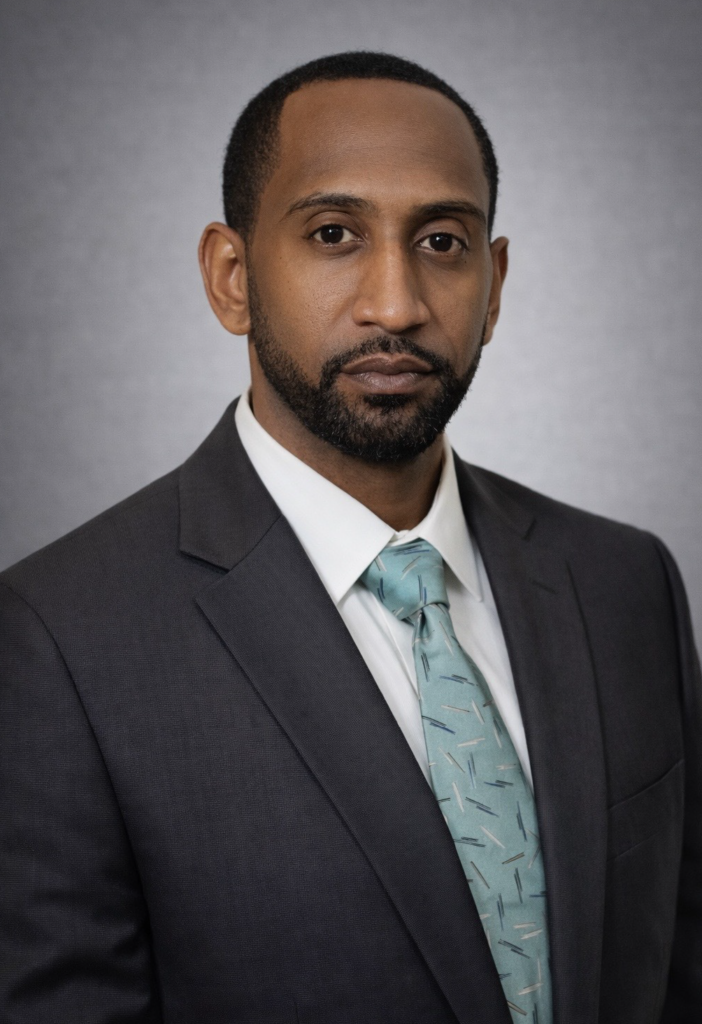 man wearing a suit, facing the camera for a headshot