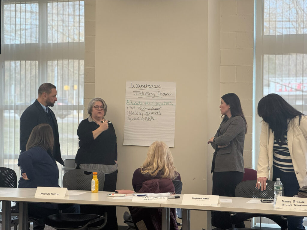 TDL partnerships working together on brainstorming ideas on a large sheet of paper