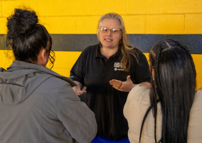 Woman talking to job seekers at TDL job Fair