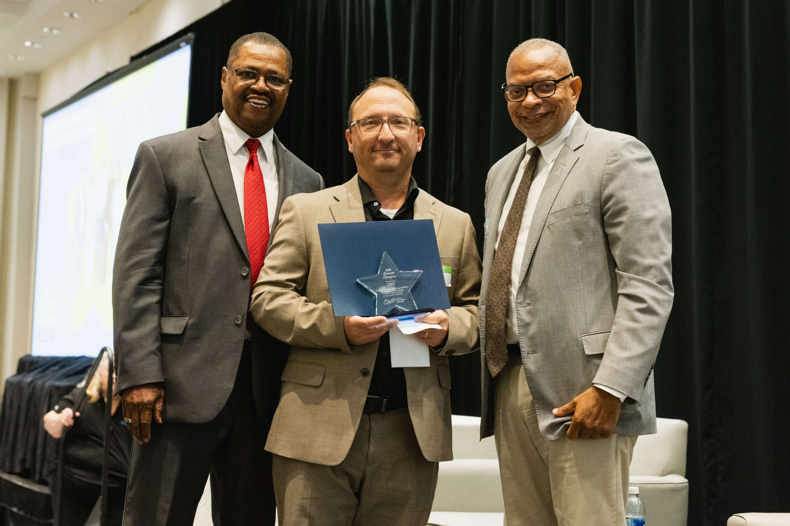COCC representative accepting award at 2026 CWP Annual Meeting with CWP leadership by his side.