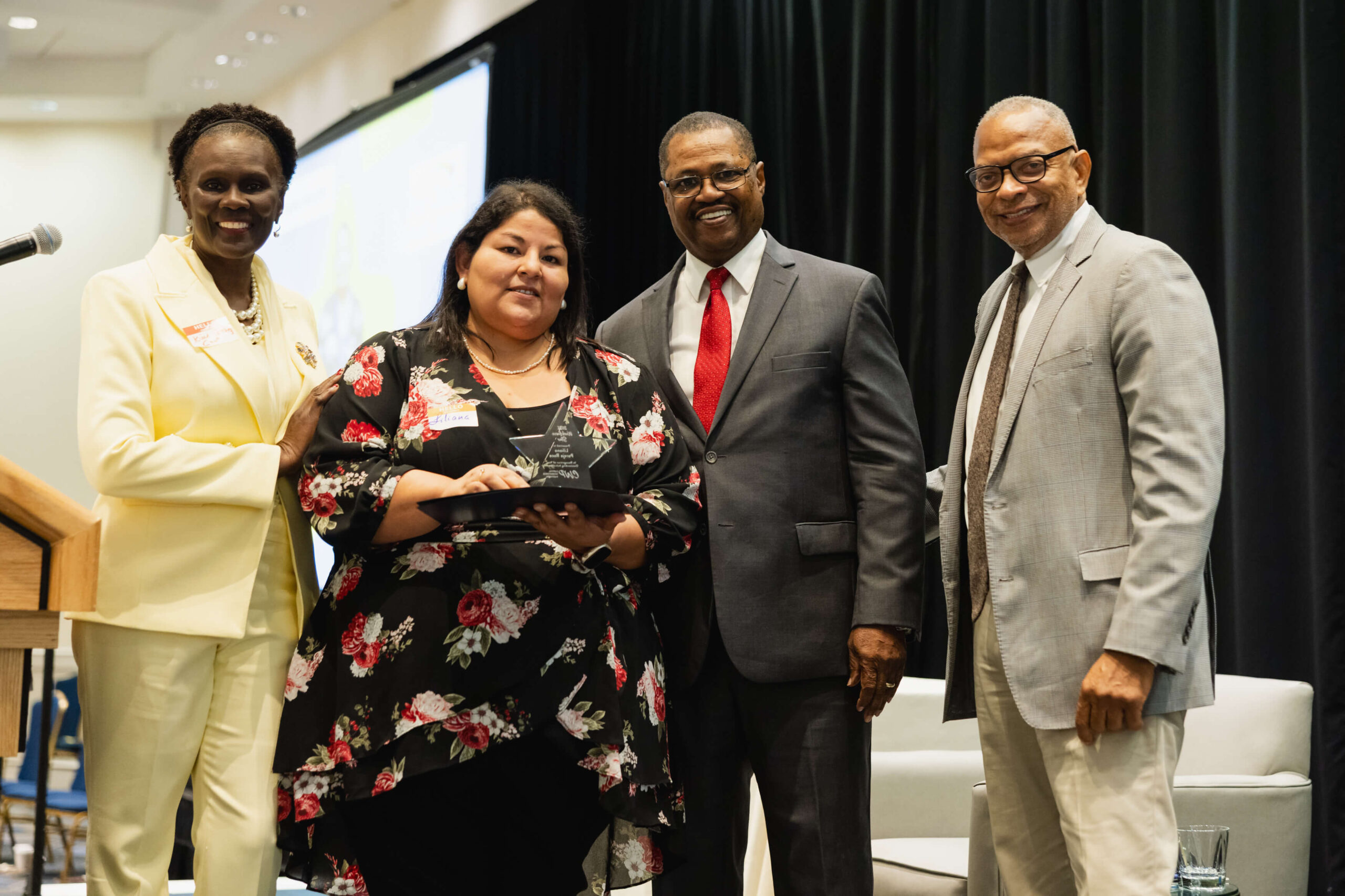 CT Jobseeker accepting award in hartford at CWP 2026 Annual Meeting, with CWP Leadership by her side.